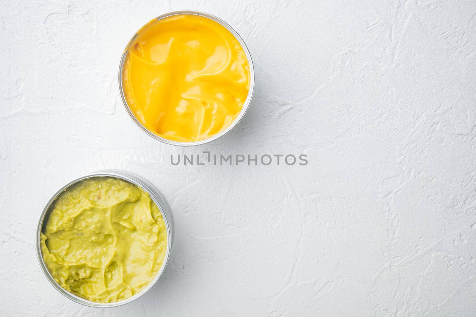 Canned guacamole and cheese dip in can, on white background, top view or flat lay with copy space for text