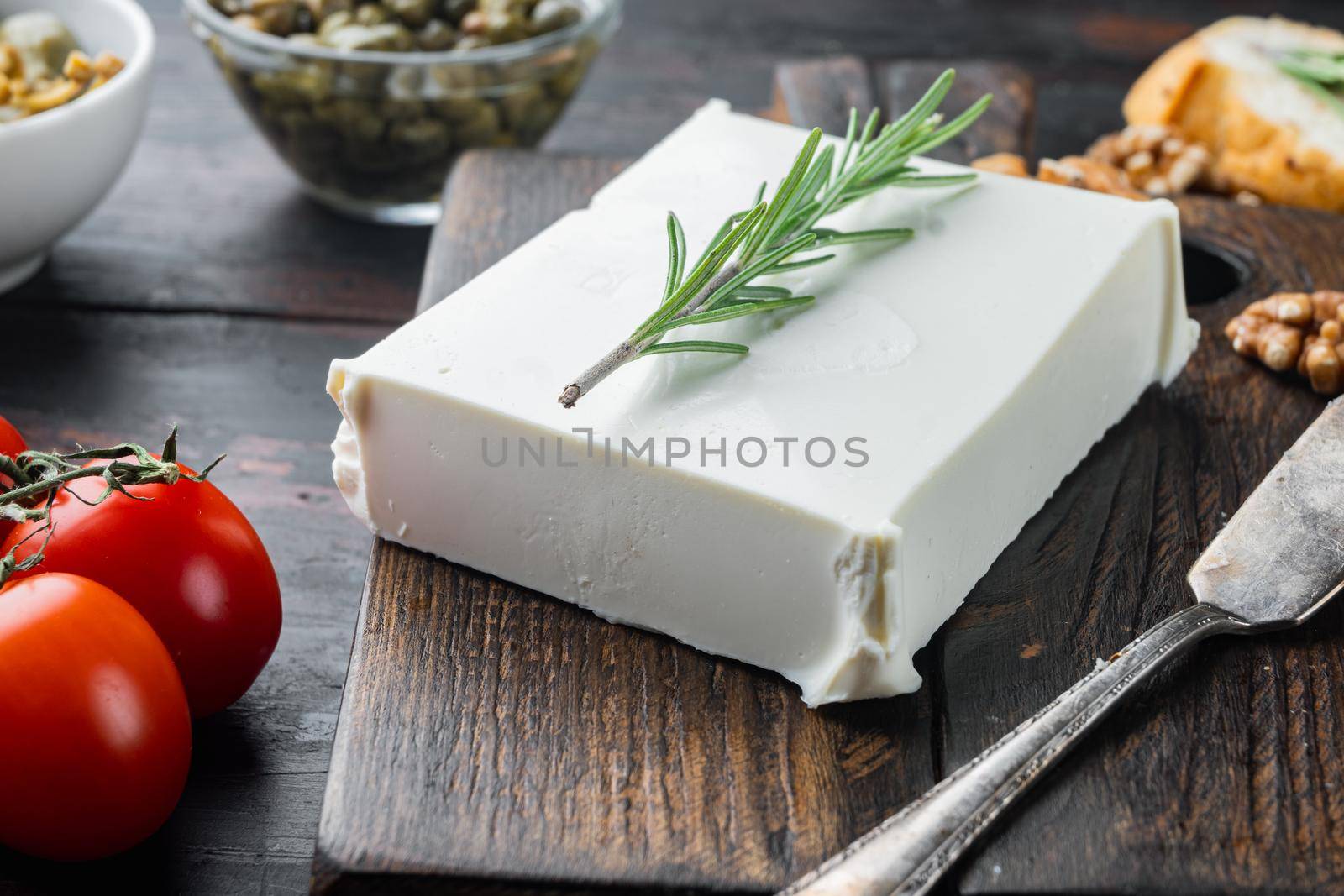 Traditional greek feta cheese set, on dark wooden background