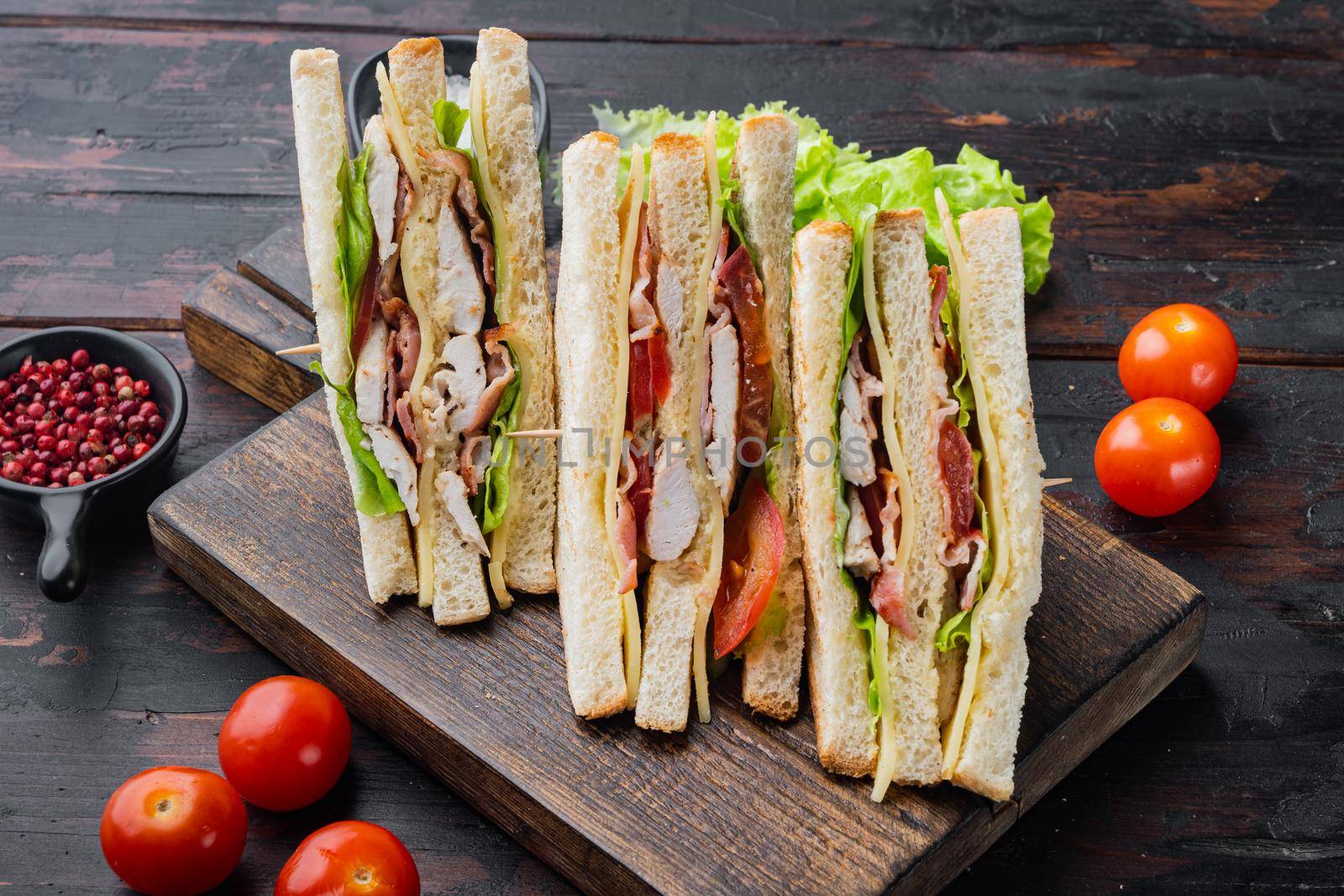 Deli fresh sandwich with chicken, on dark wooden background