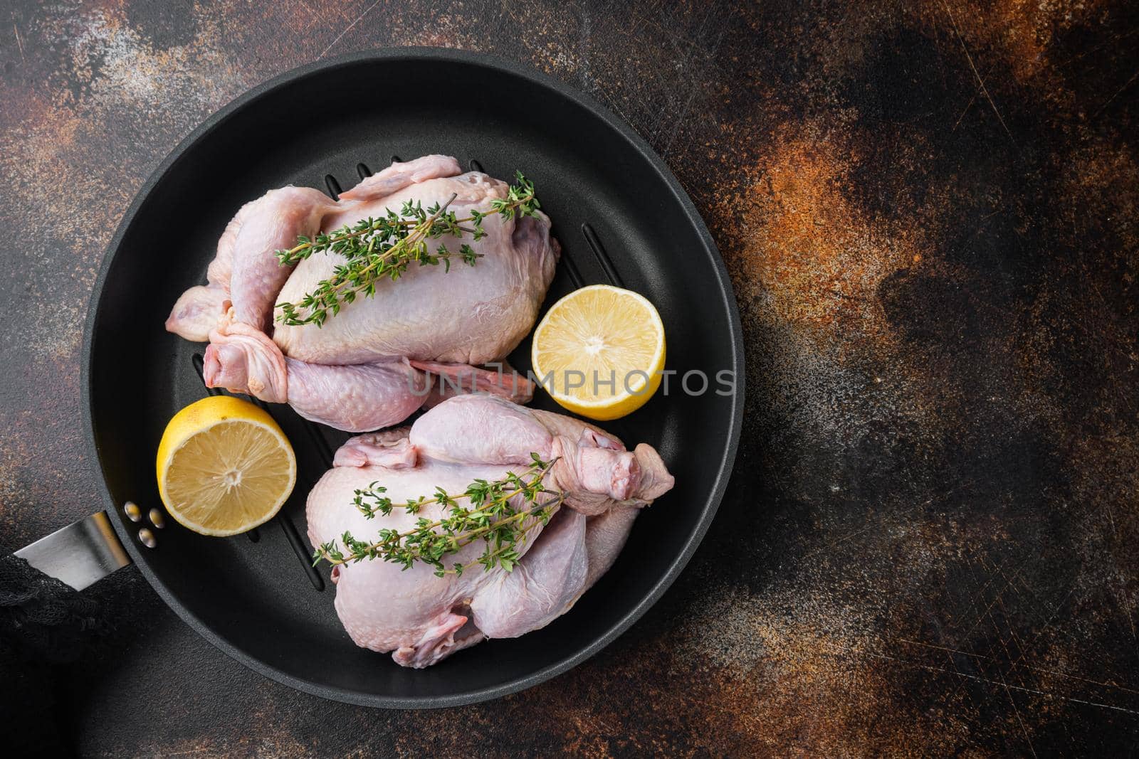 Fresh whole poult meat on grill pan, on old rustic background, top view with copy space for text