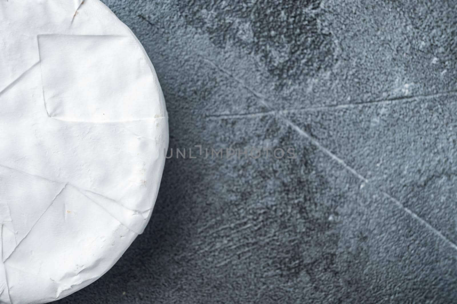 Camembert or brie cheese set, on gray background, top view with copy space for text