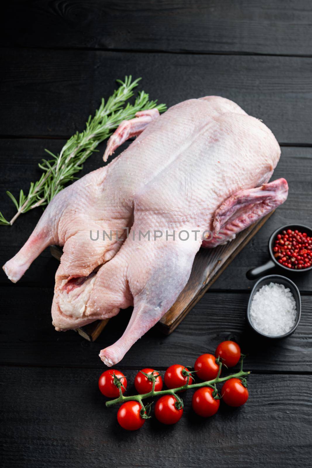 Raw duck fresh meat on black wooden table.