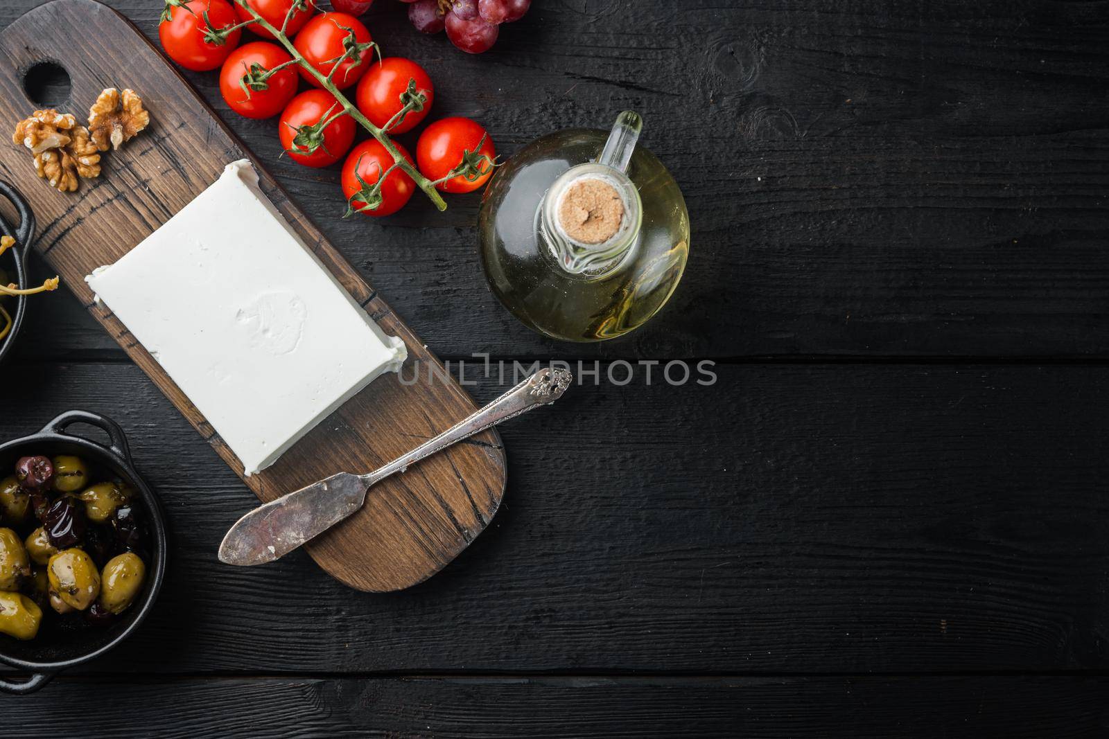 Cheese feta greek salad ingredient, on black wooden table, flat lay with copy space for text