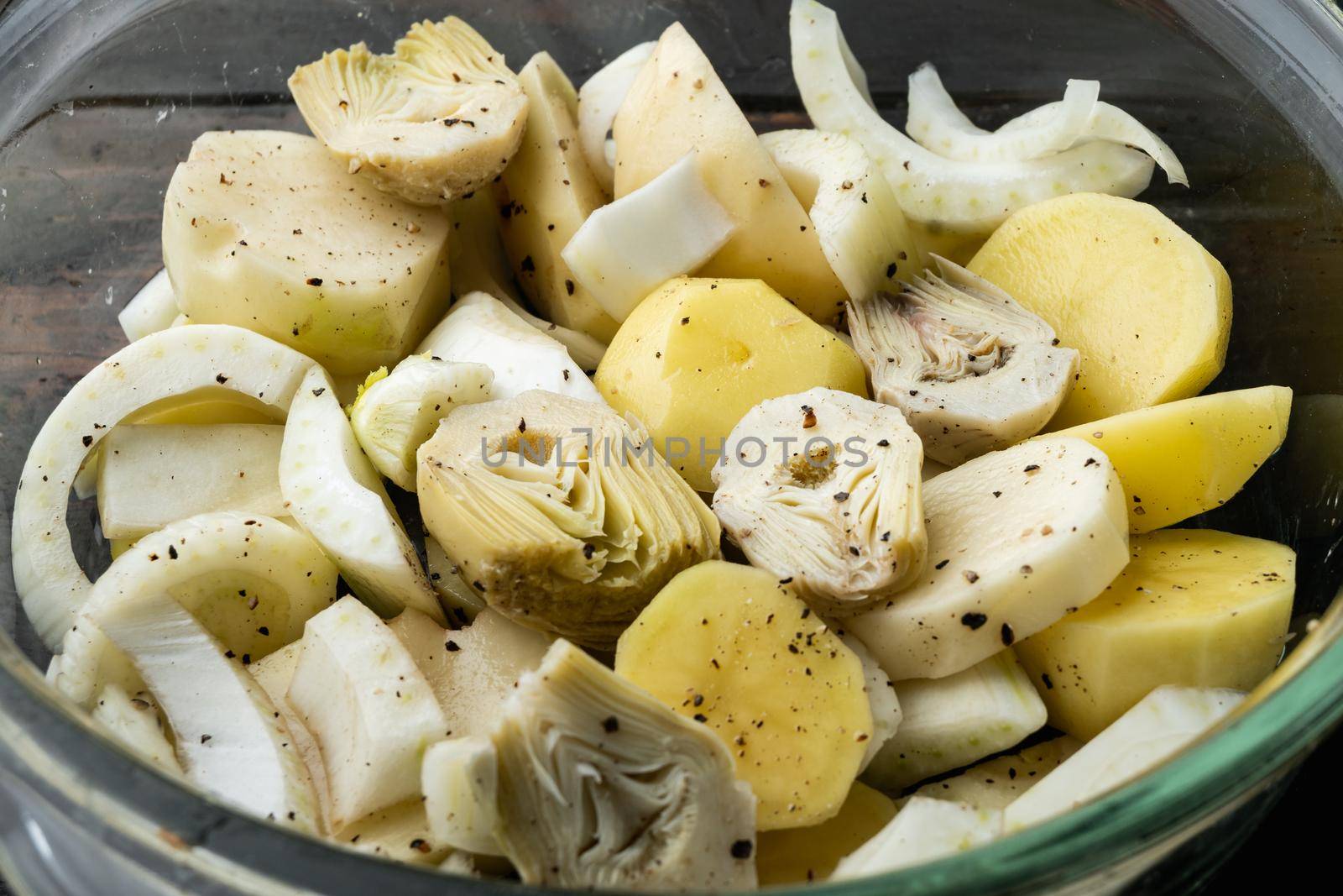 Potato and artichoke with fennel for baking raw ingredients, on old wooden table