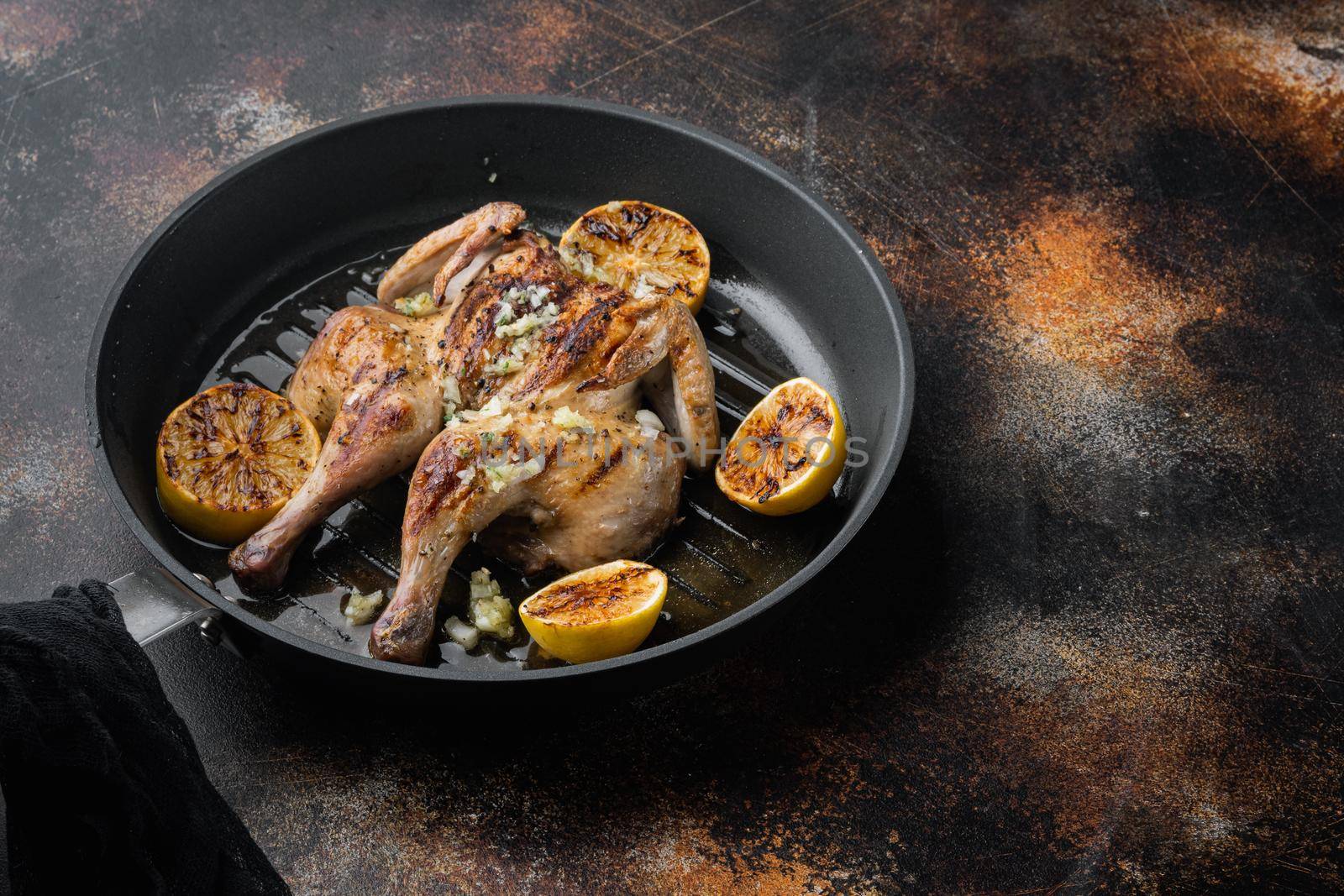 Homemade chicken rotisserie with thyme and lemon, on old rustic background with copy space for text