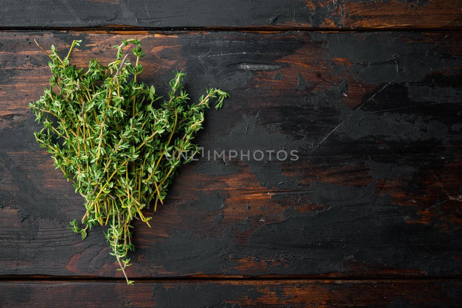 Thyme green fresh bunch, on old wooden table, top view with copy space for text