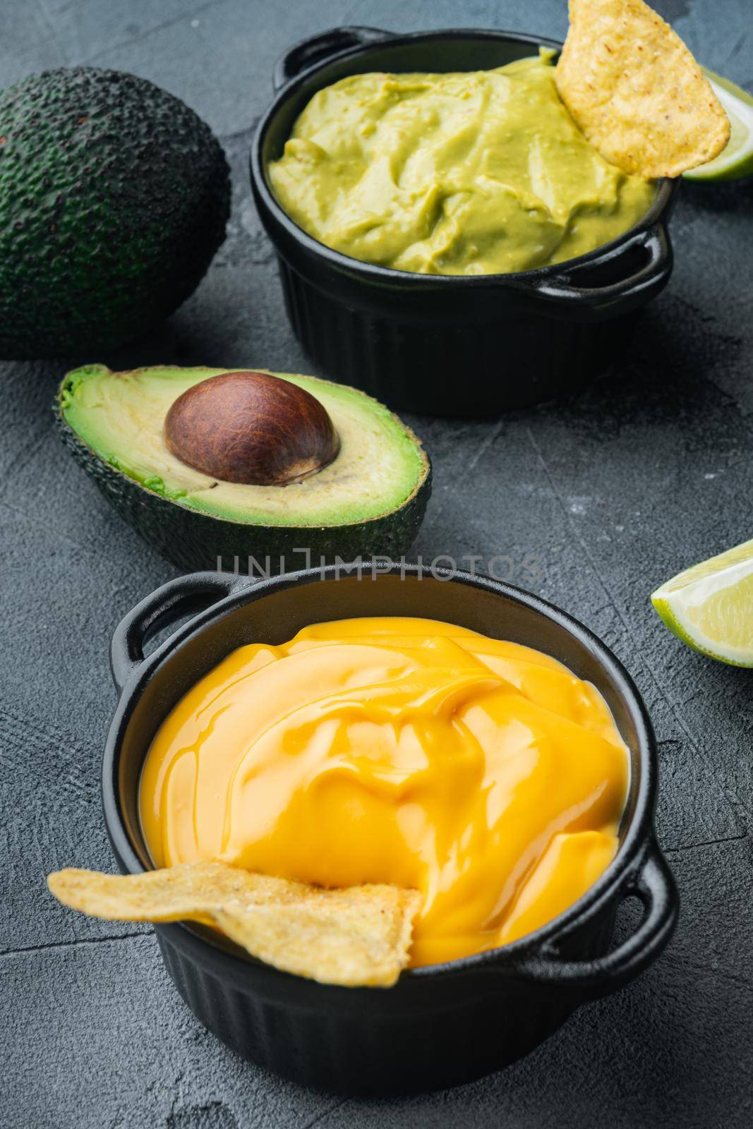 Creamy cheddar sauce with chia seeds in bowl, on gray background