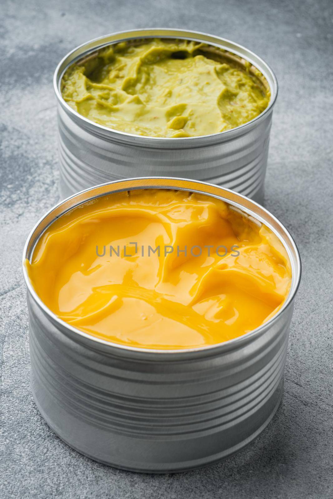 Canned guacamole and cheese dip in can, on gray background