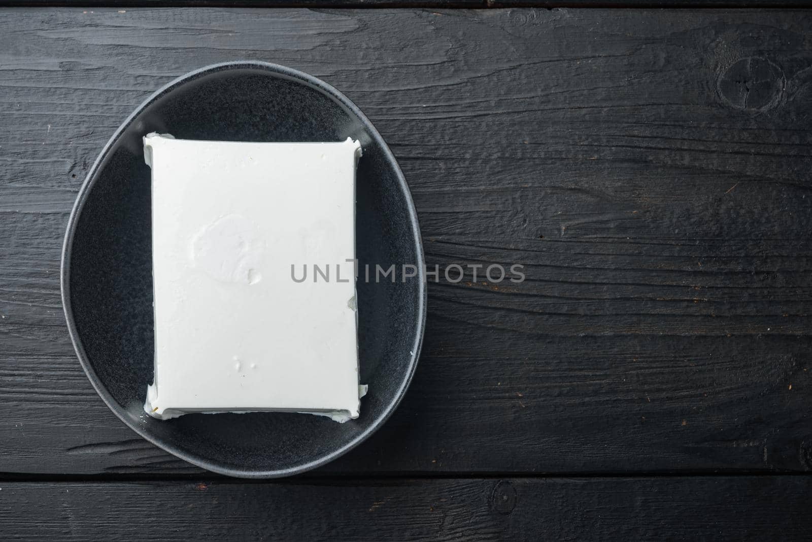 Fresh greek feta cheese set, on black wooden background, flat lay with copy space for text