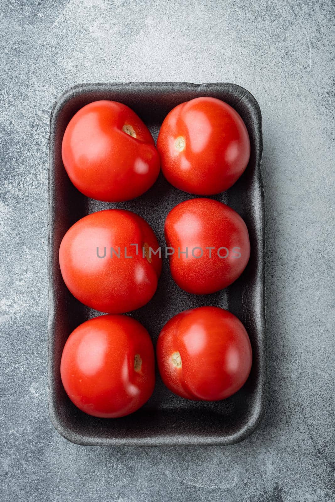 Red ripe tomatoes, on gray background