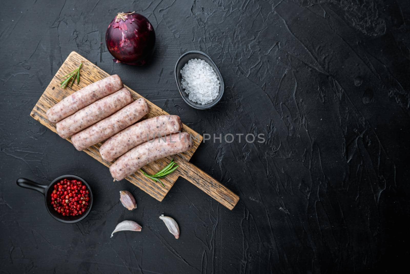Traditional mest sausages, flat lay with space for text, on black background.