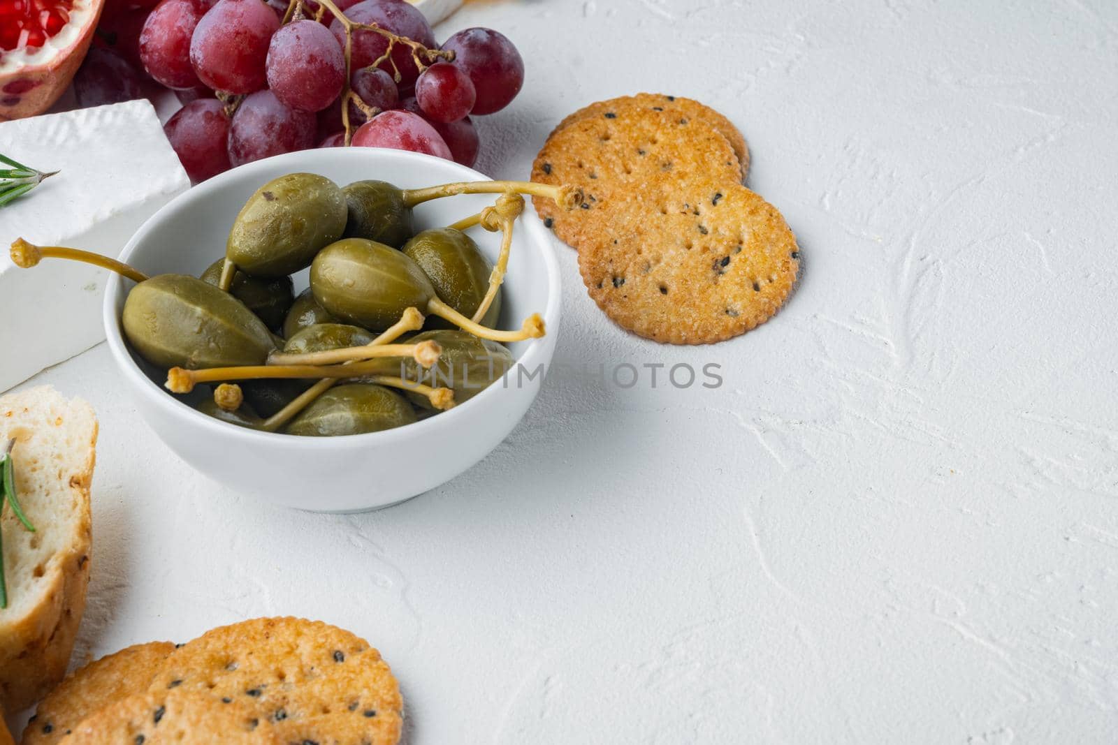Capers, marinated in oil, on white background with copy space for text