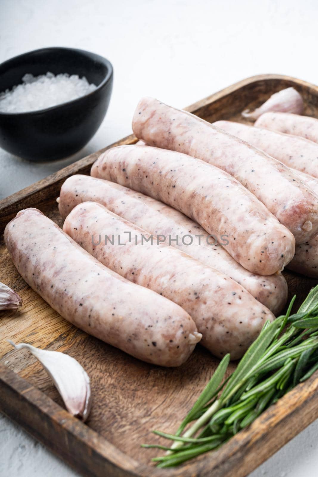 Homemade chicken meat sausages, on white background.