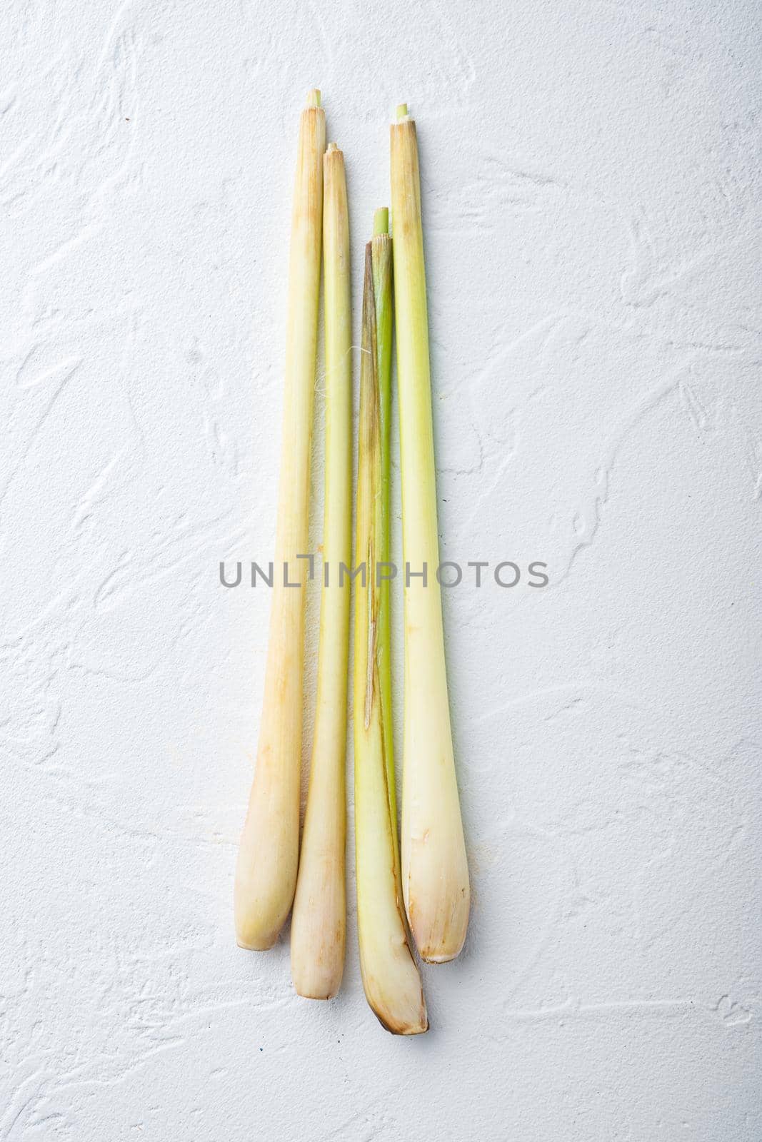 Stick of fresh lemongrass, on white textured background, flat lay