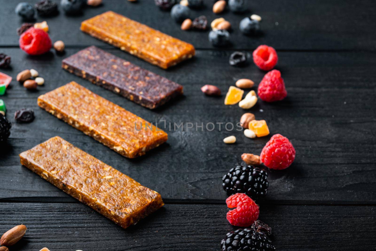Dried fruits energy bars, on black wooden table