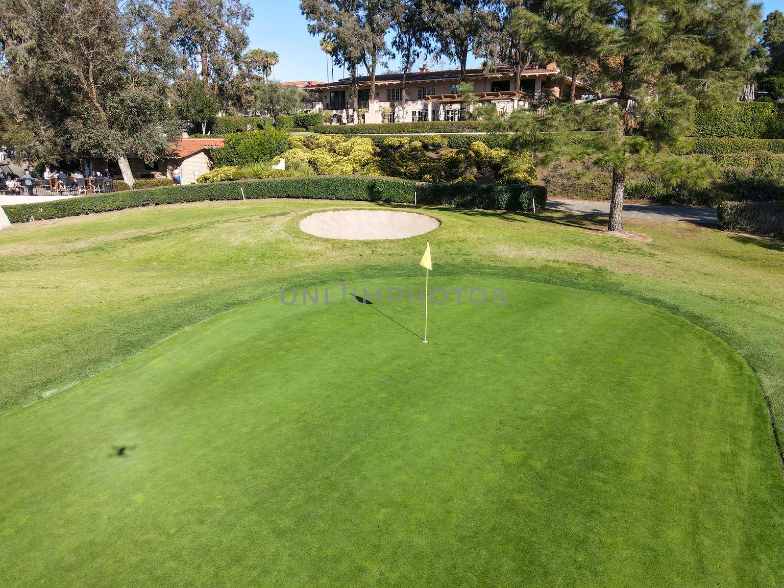 Aerial view of flag mark in hole on golf field. Game, entertainment, sport and leisure concept -