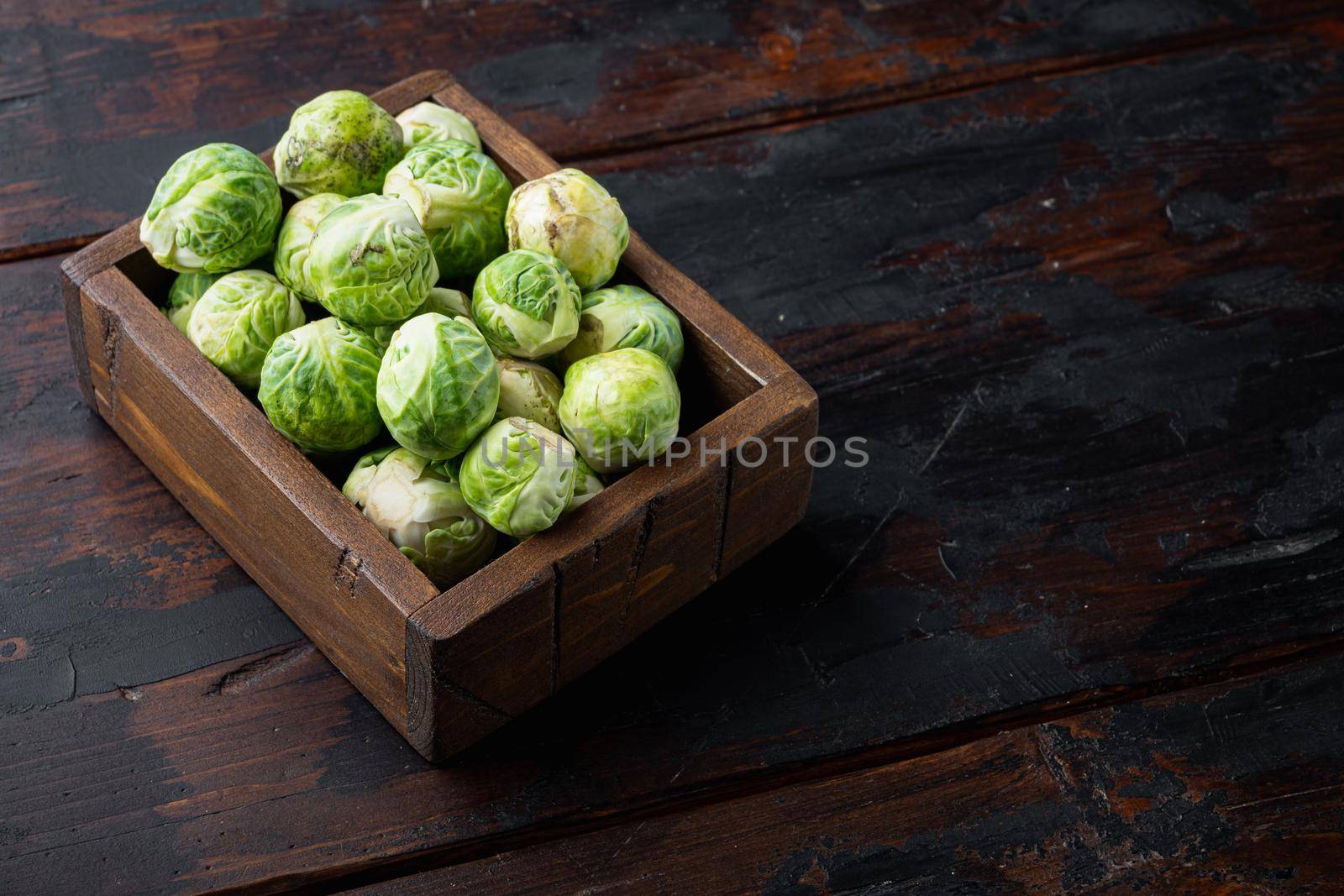 Raw brussels sprouts, on old wooden table with space for text