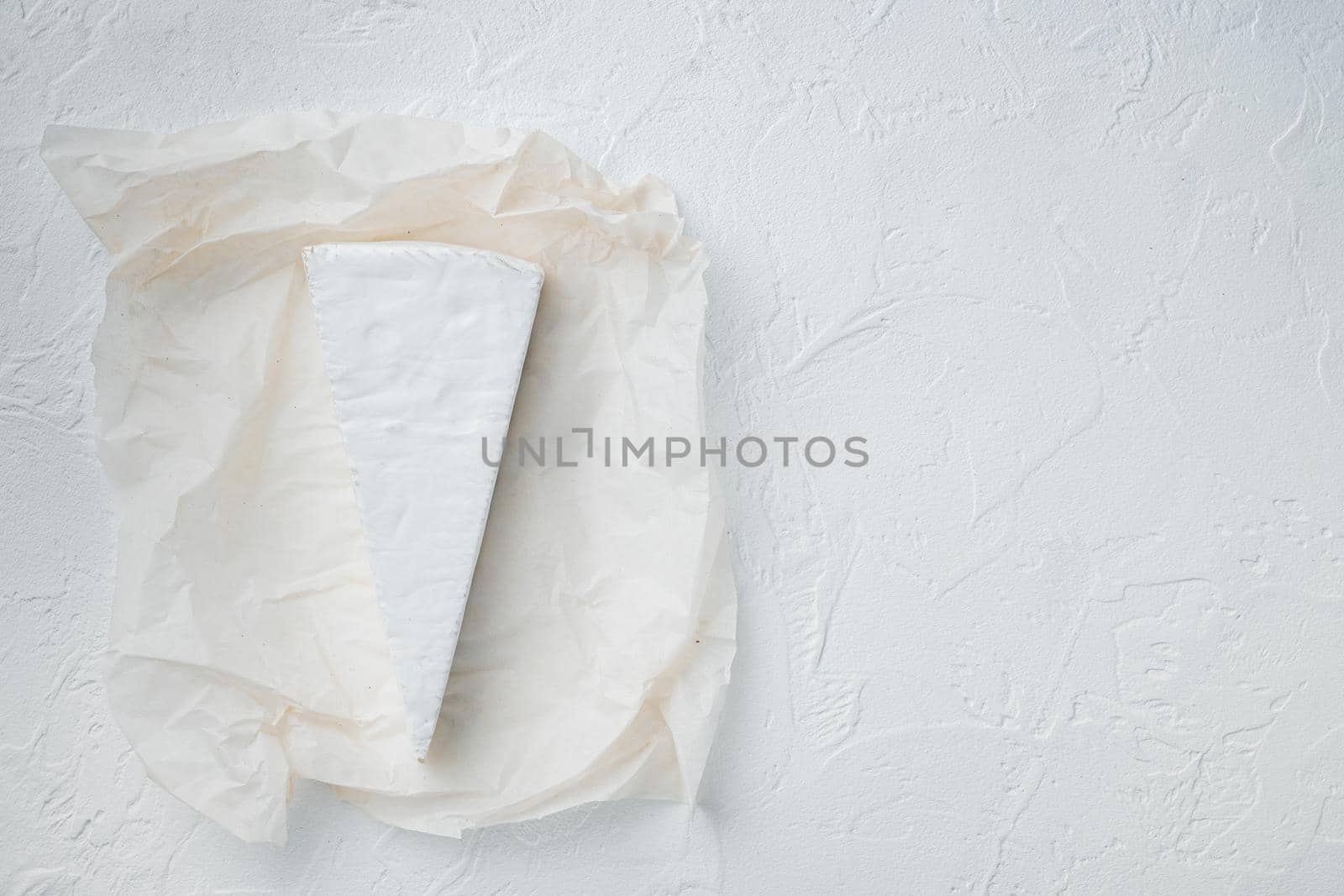 Delicious brie cheese piece, on white background, top view with copy space for text