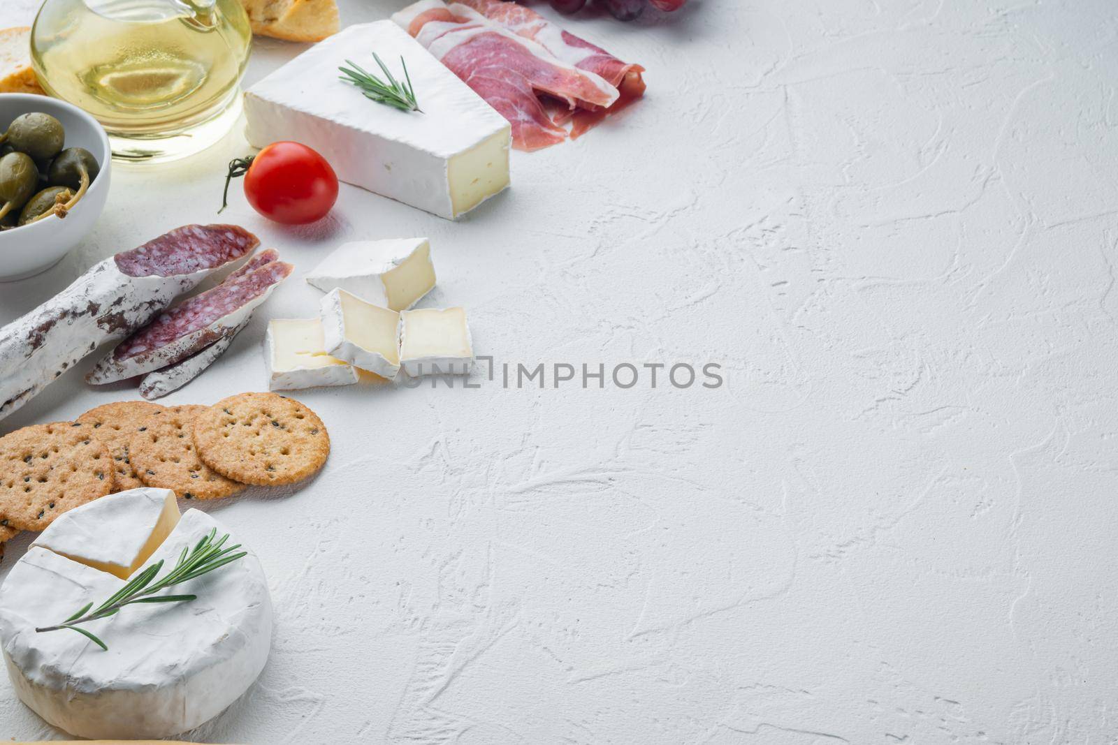 Assortment of cheese and meat appetizers set, on white background with copy space for text