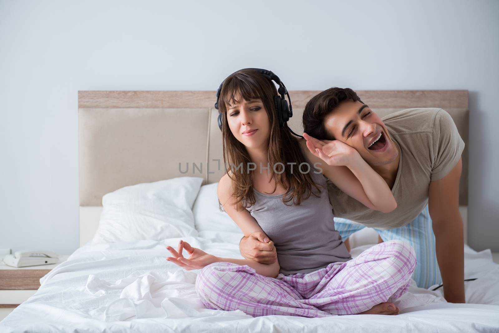 Young family meditating in the bed bedroom by Elnur