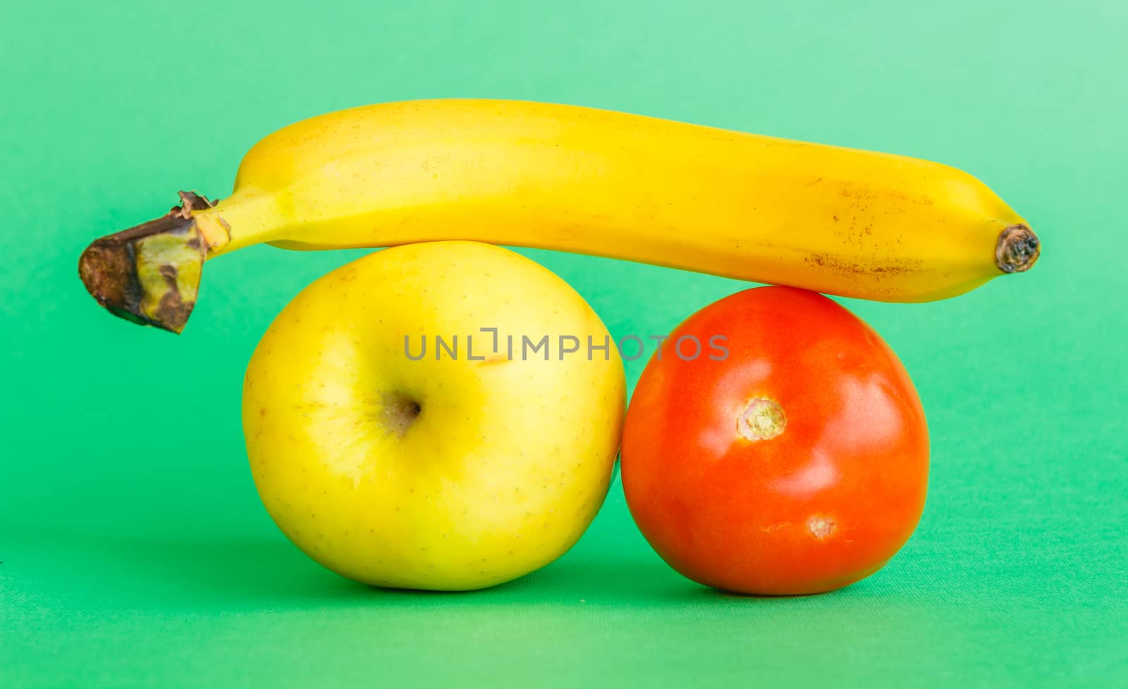 a banana, an apple and a tomato