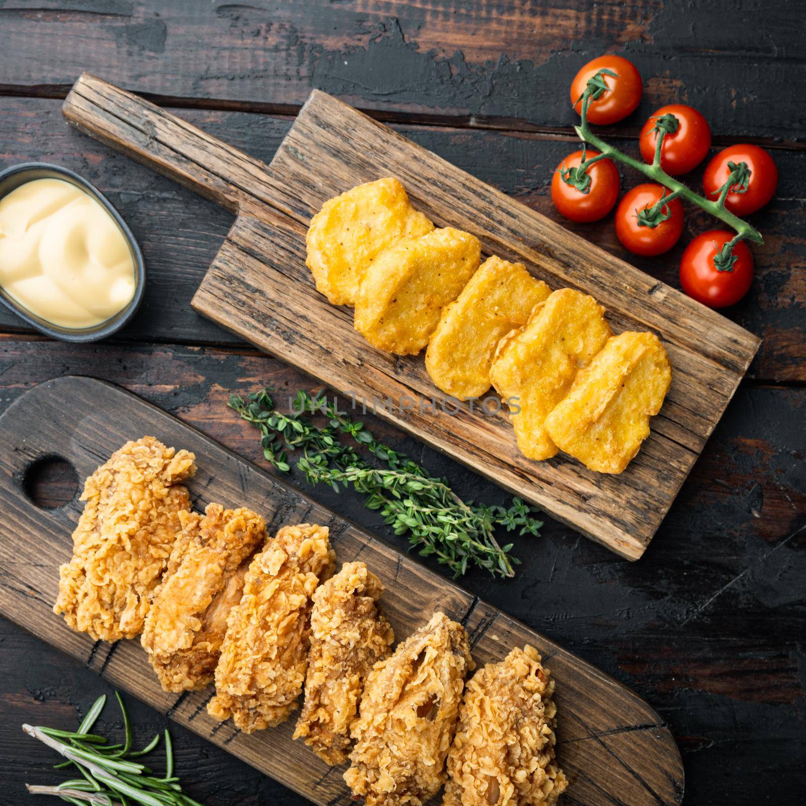 Korean barbeque fried chicken cuts on old dark wooden table, flat lay.