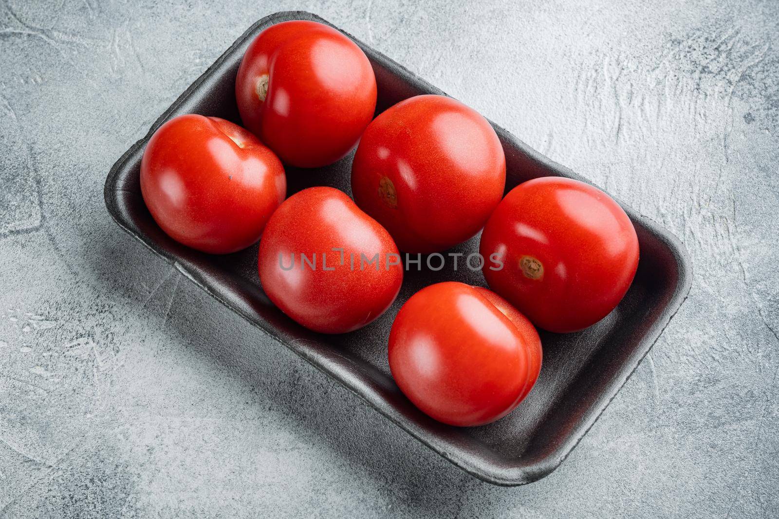 Red tomatoes, on gray background