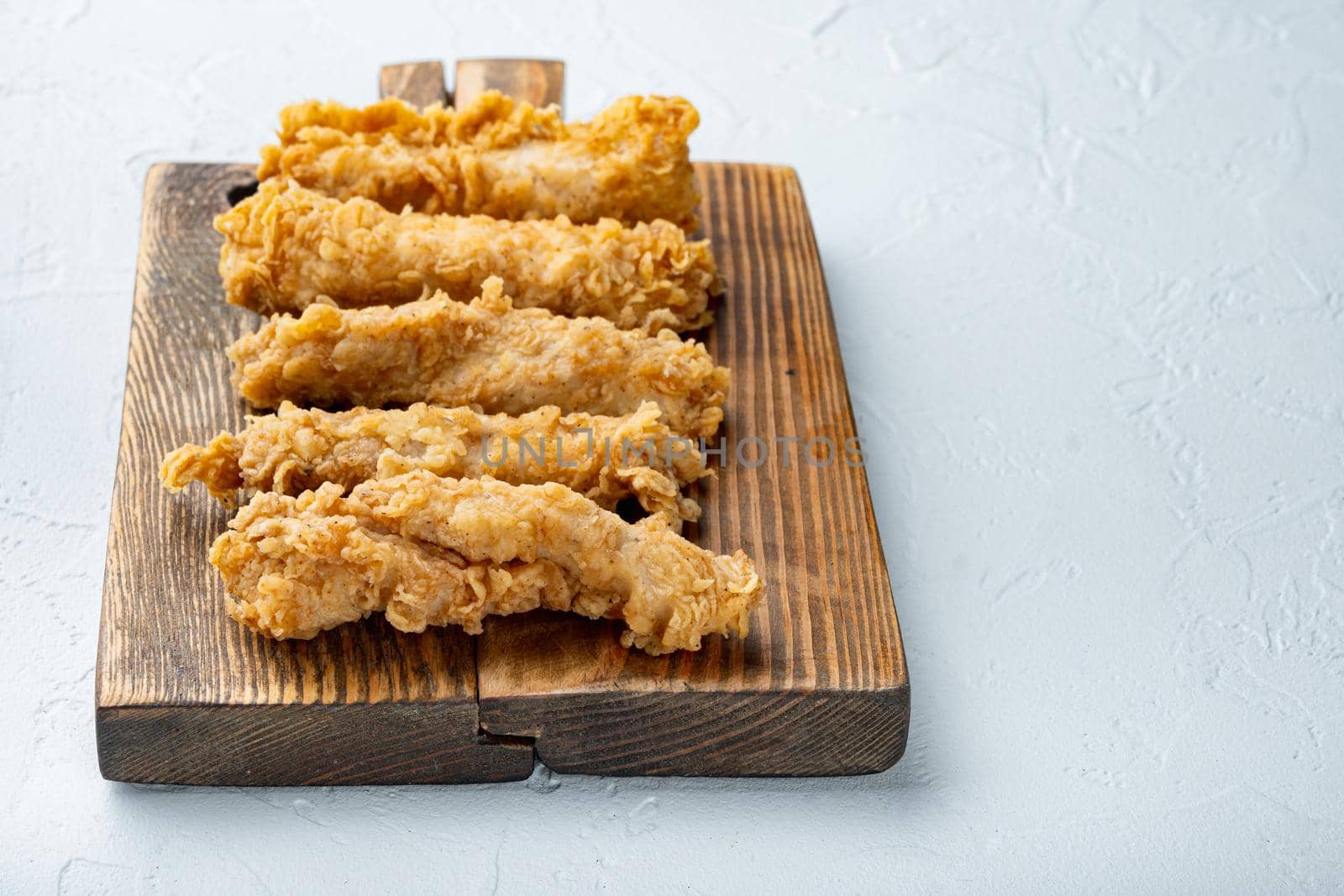 Chicken breaded wingshell meat on white background, with copy space.