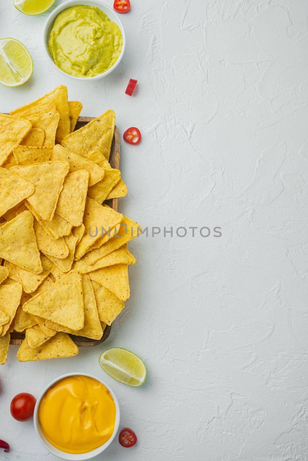 Corn tortilla chips nachos and dip sauce, on white background, top view or flat lay with copy space for text