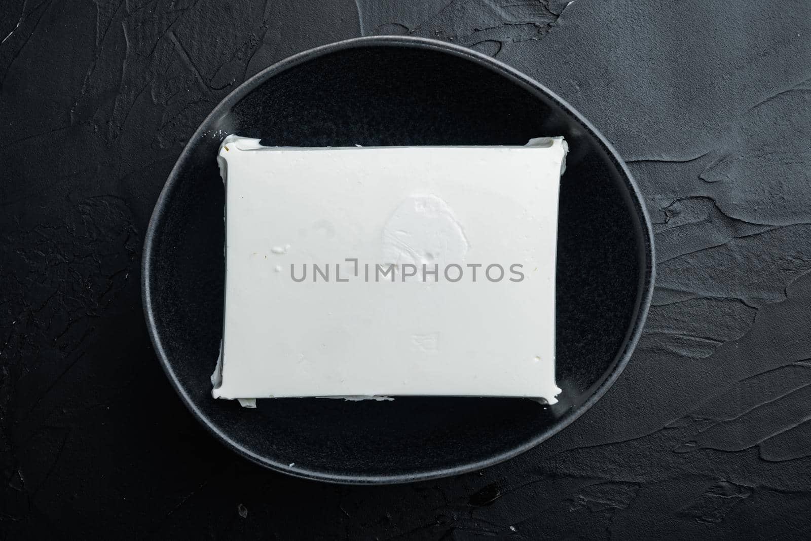 Traditional greek feta cheese set, on black background, top view