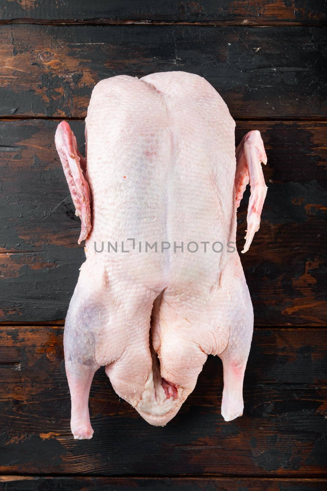 Recipe for cooking whole duck meat on old dark wooden table, flat lay.