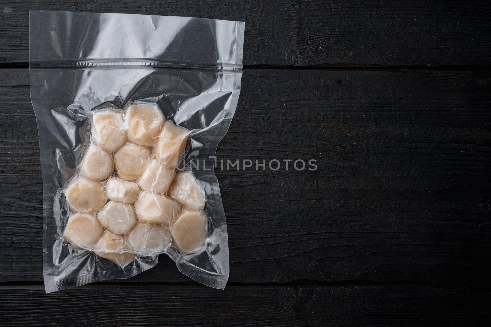 Frozen meat scallops in vacuum package, flat lay with space for text