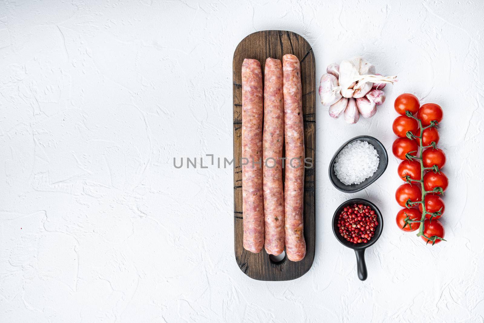 Traditional beef sausages, top view with space for text, on white background.