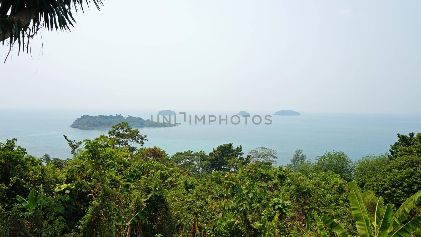 An observation deck with views of the sea. The whole sea is in smoke from a fire in Cambodia. Strong gas pollution of nature. Ecological disaster. View of the beaches and palm trees. Thailand.