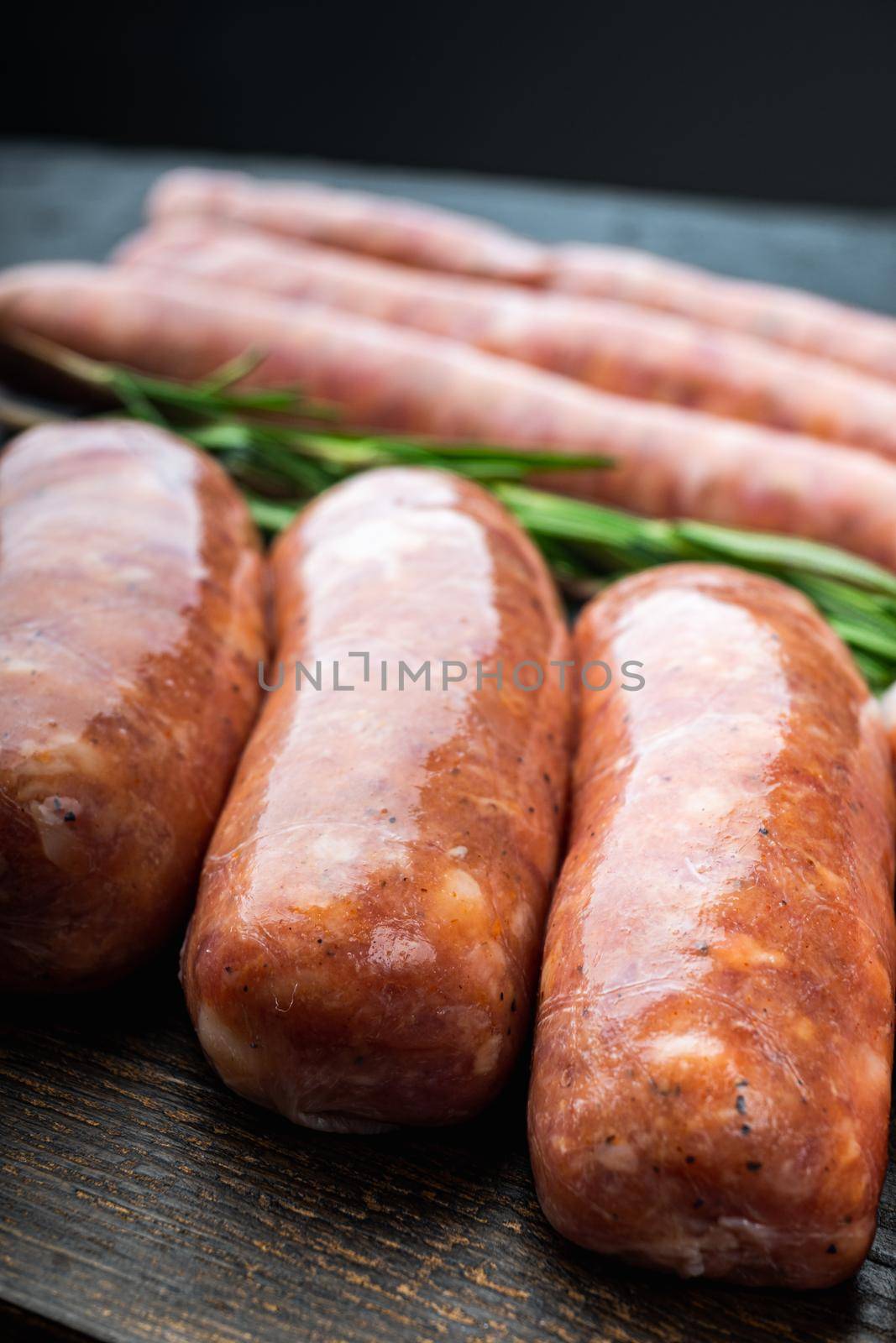 Traditional pork sausages, on black background.
