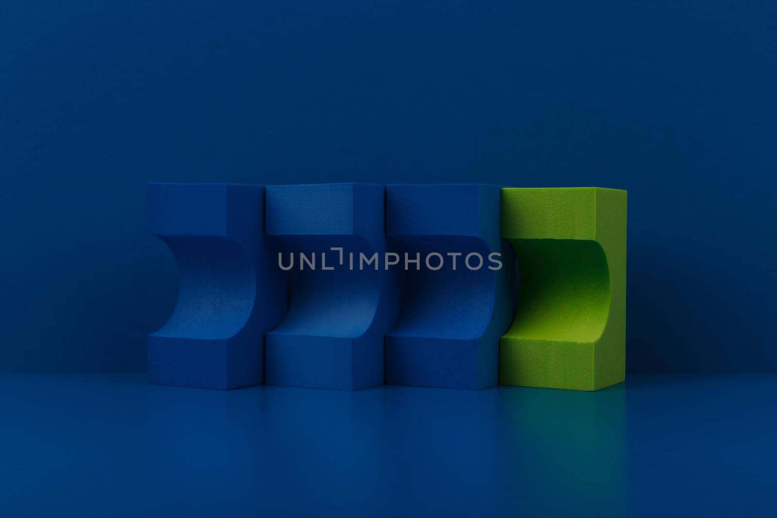 Abstract duotone background with blue and green figures on blue reflective table against blue background. Concept of advertising or promotional tamplate