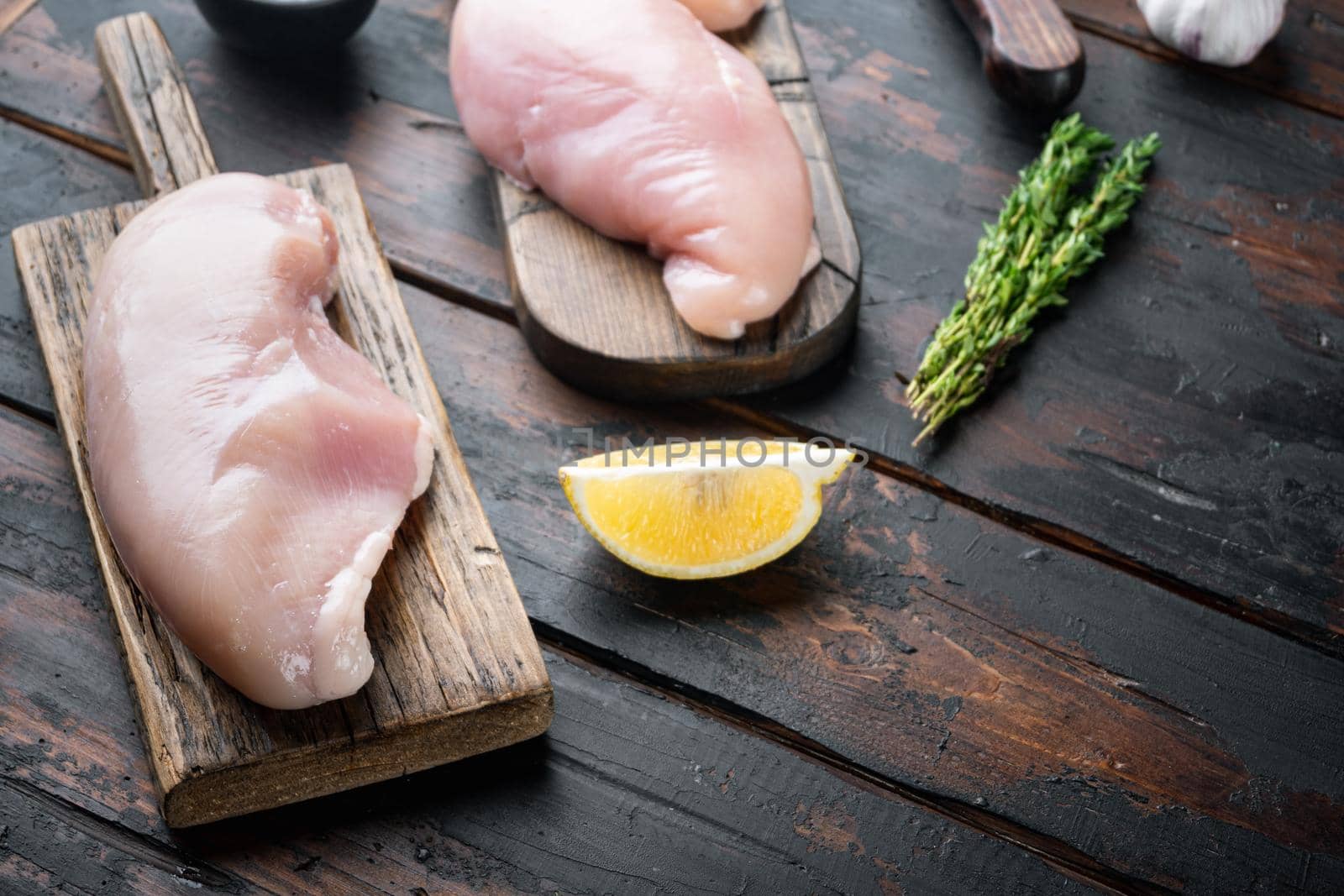 Crispy garlicky chicken raw ingredient, on dark wooden background with copy space