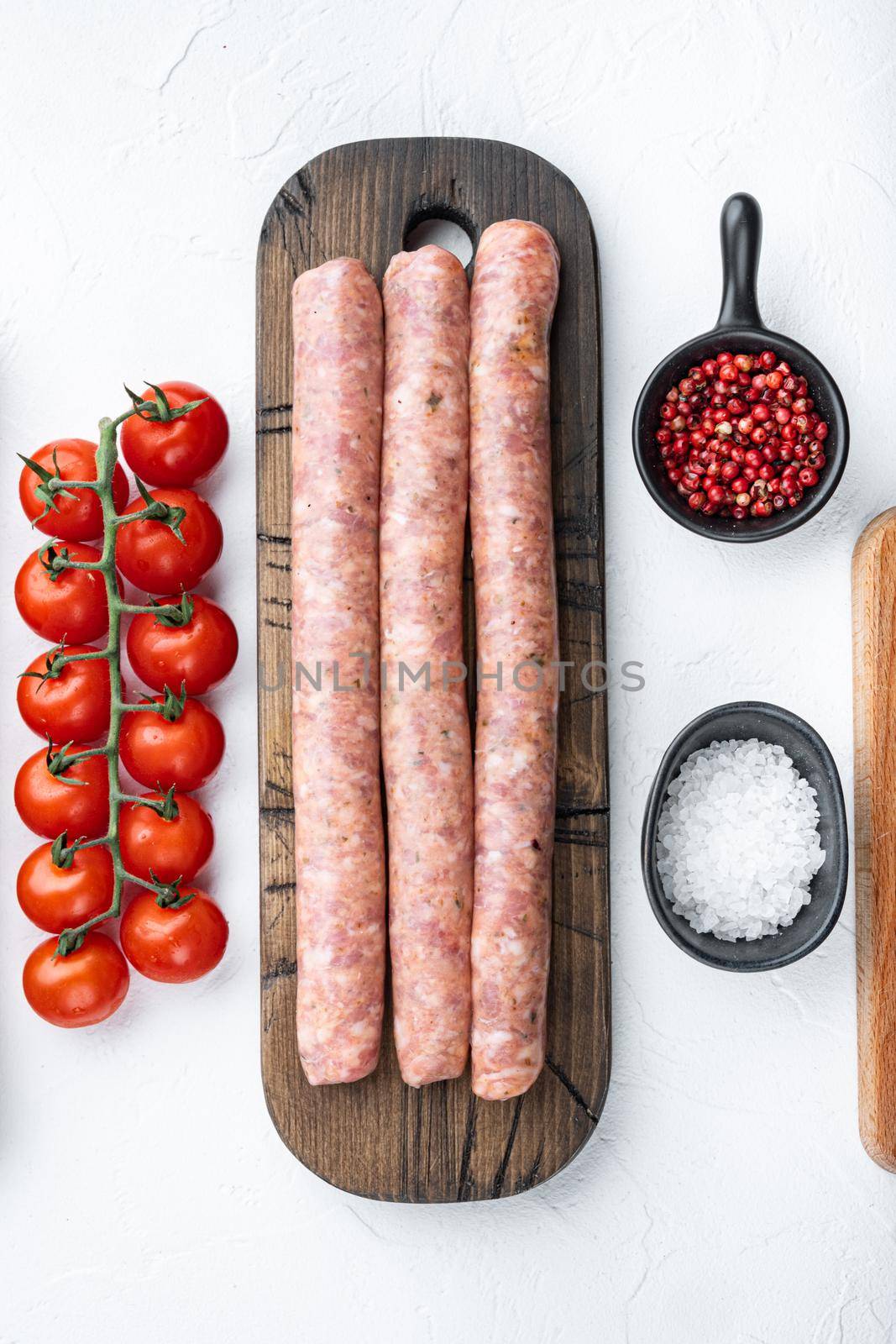 Beef sausages, flat lay, on white background.