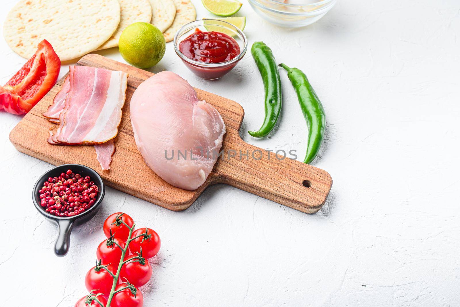 Mexican tacos with vegetables and meat Ingredient for cooking over white textured background, side view with space for text