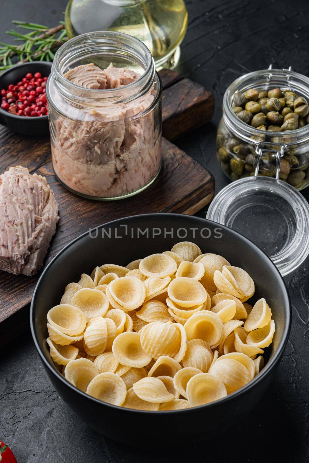 Tuna pasta shells ingredient, on black background