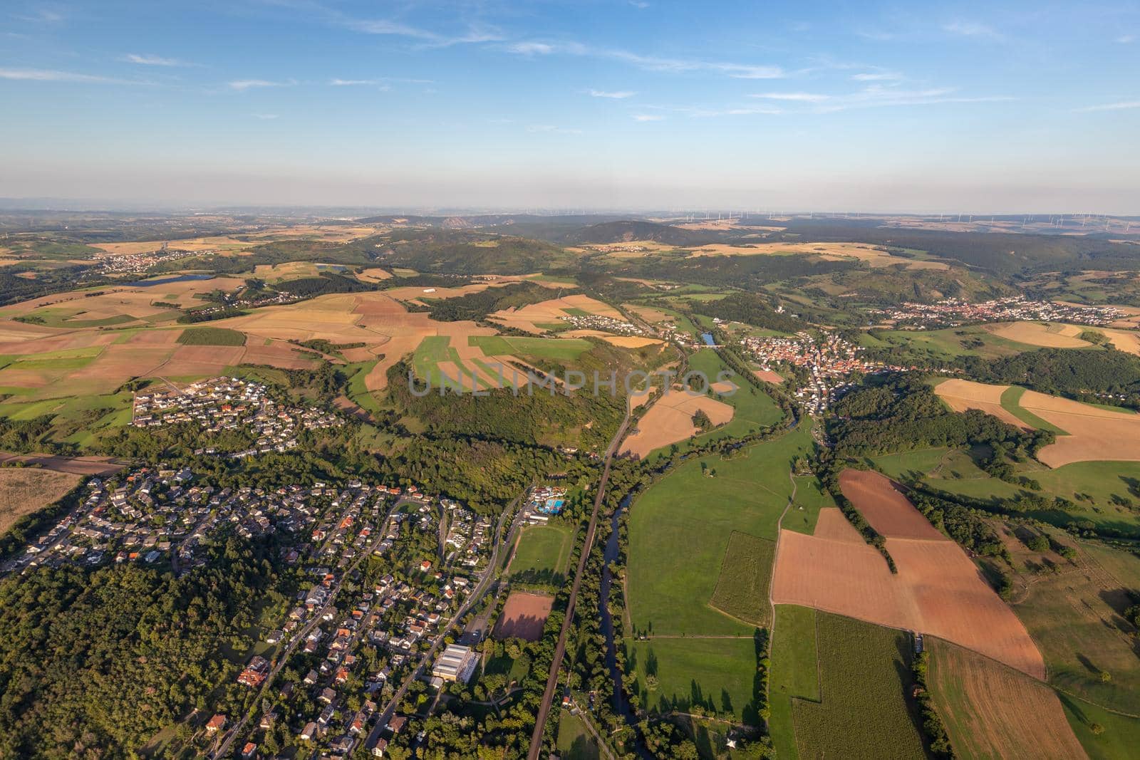 Aerial view at a landscape in Germany, Rhineland Palatinate near Bad Sobernheim with the river Nahe, meadow, farmland, forest, hills, mountains 