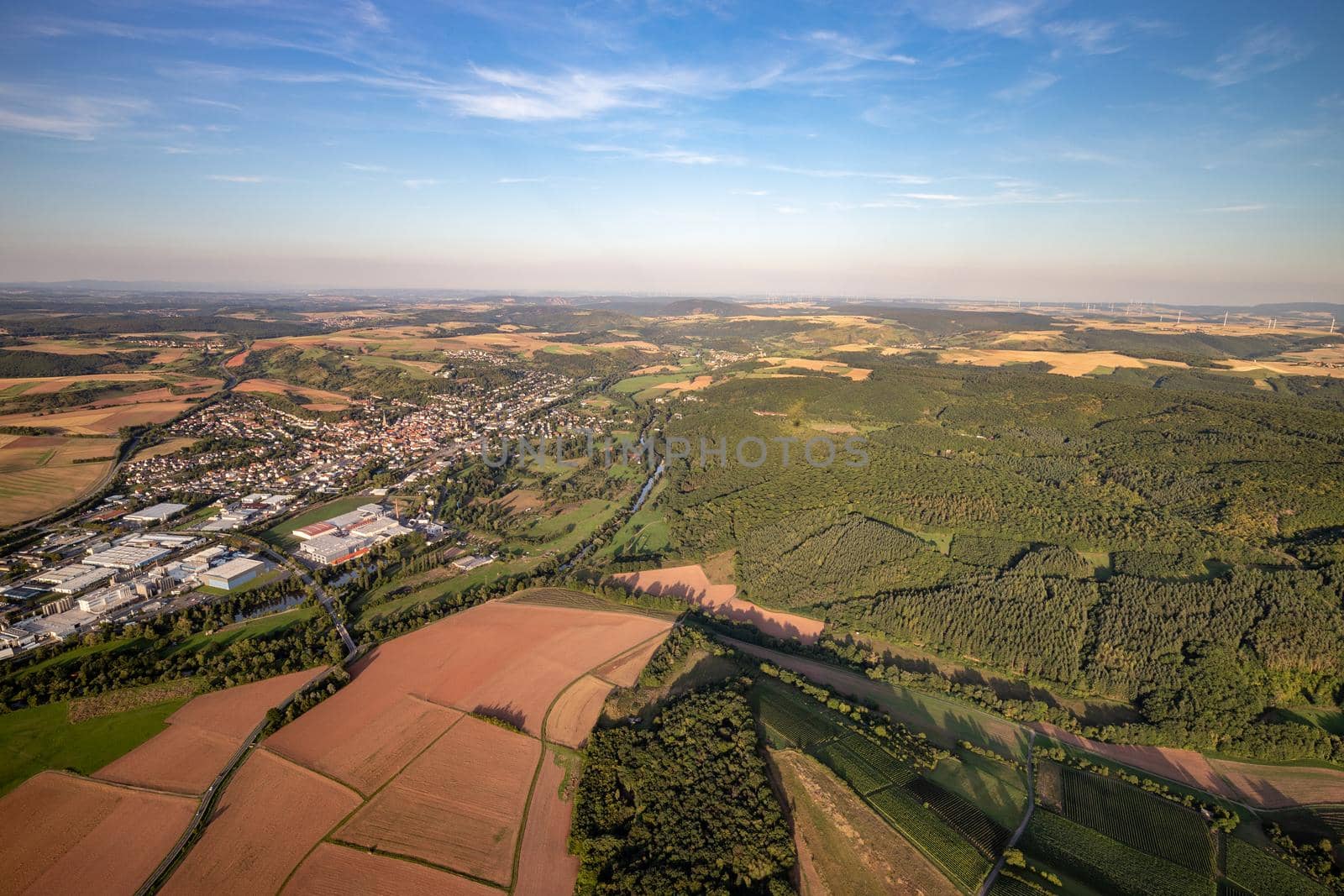 Aerial view at a landscape in Germany, Rhineland Palatinate near Bad Sobernheim with the river Nahe, meadow, farmland, forest, hills, mountains 