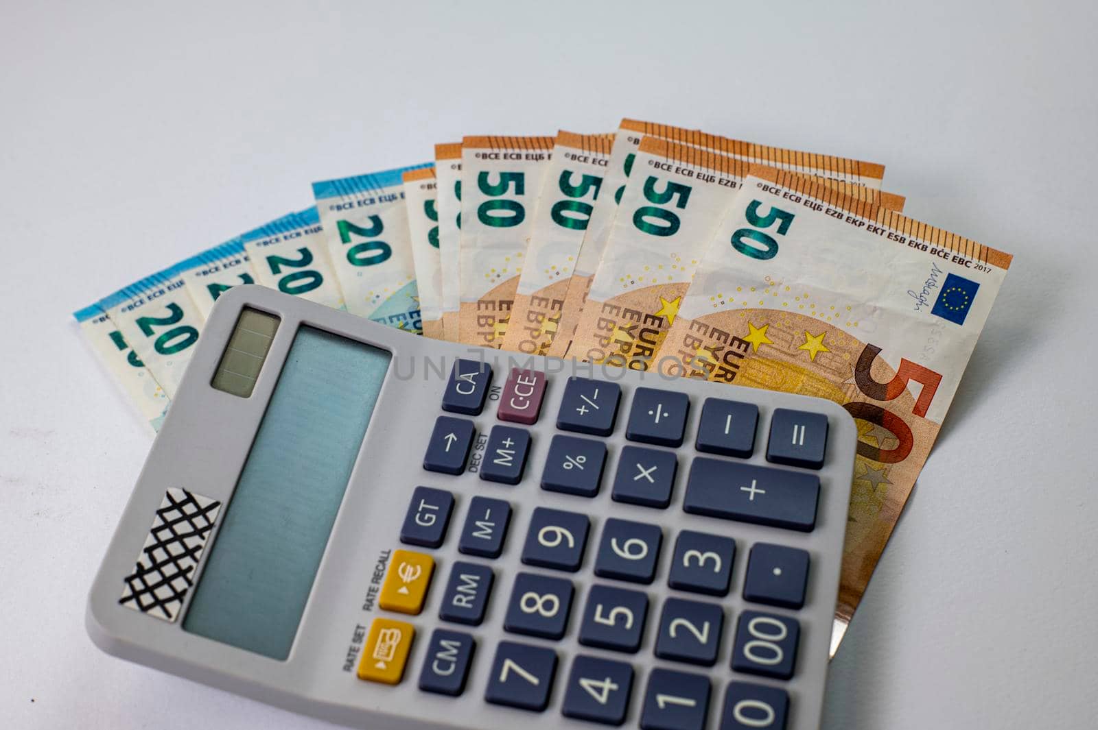 50 and 20 euro banknotes with calculator on white background