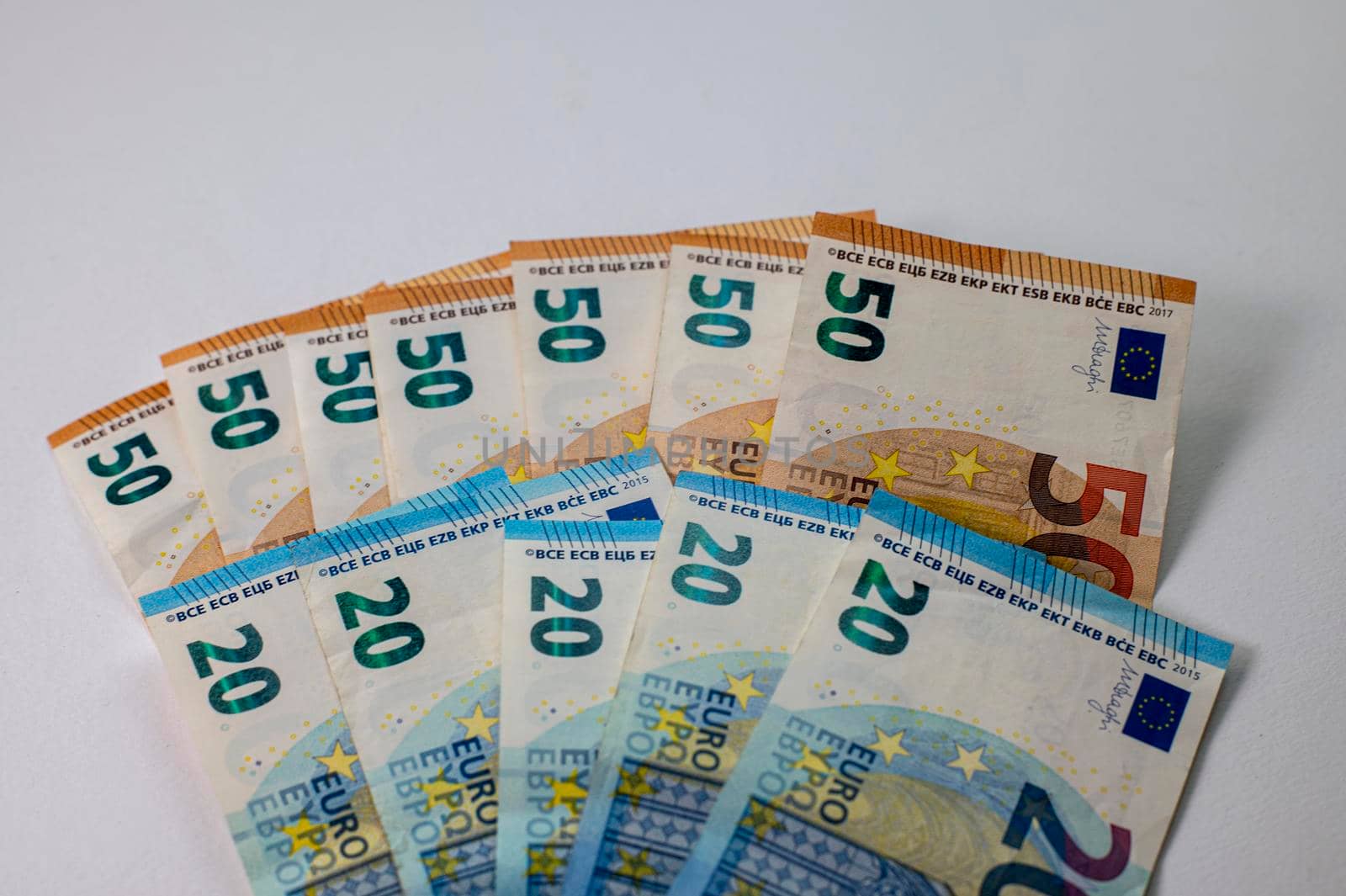50 and 20 euro banknotes fanned out on a white background