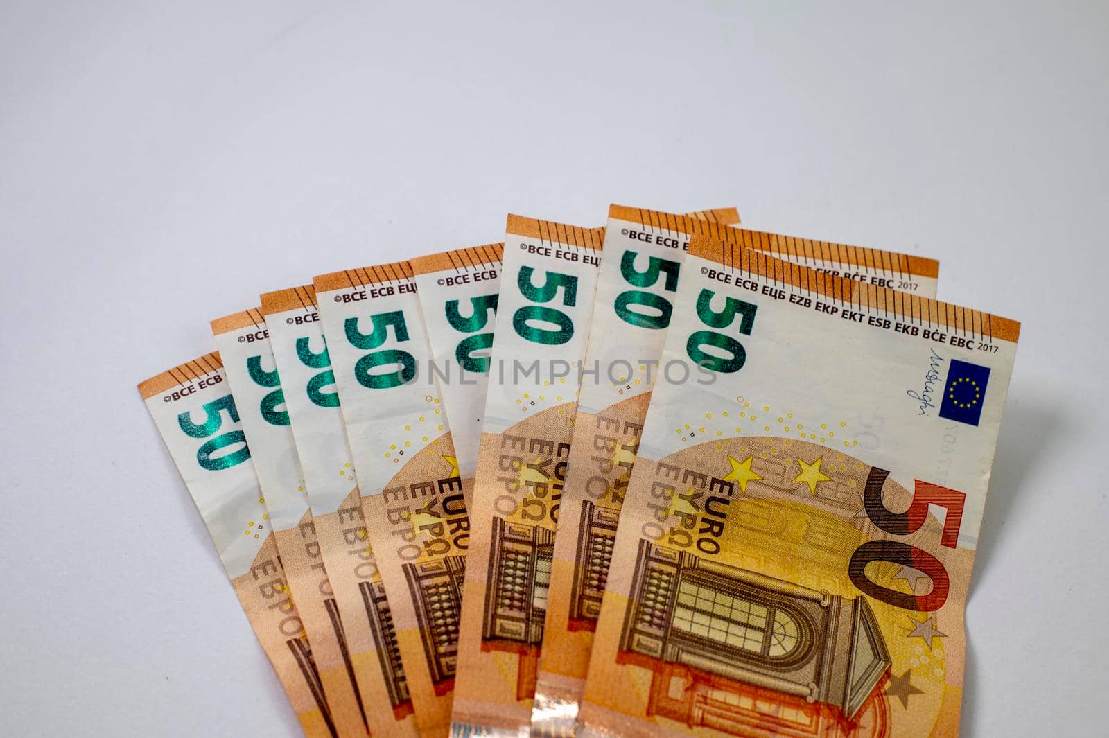 50 euro banknotes fanned out on a white background