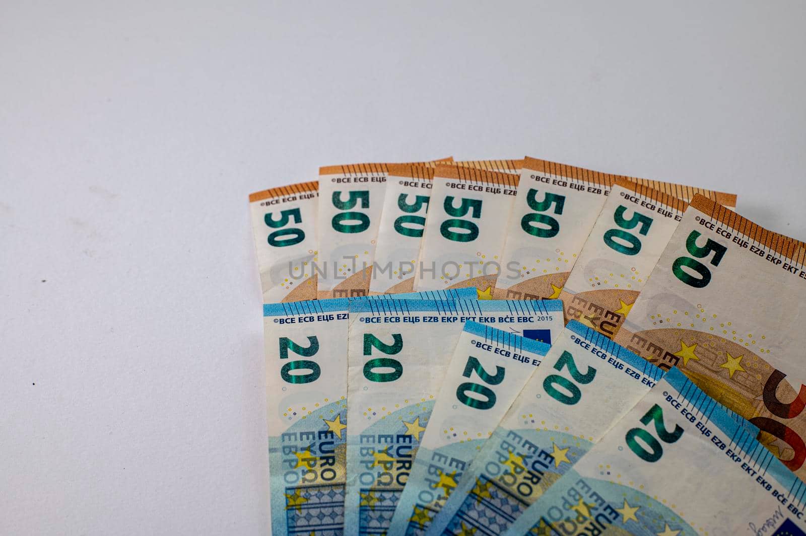 50 and 20 euro banknotes fanned out on a white background