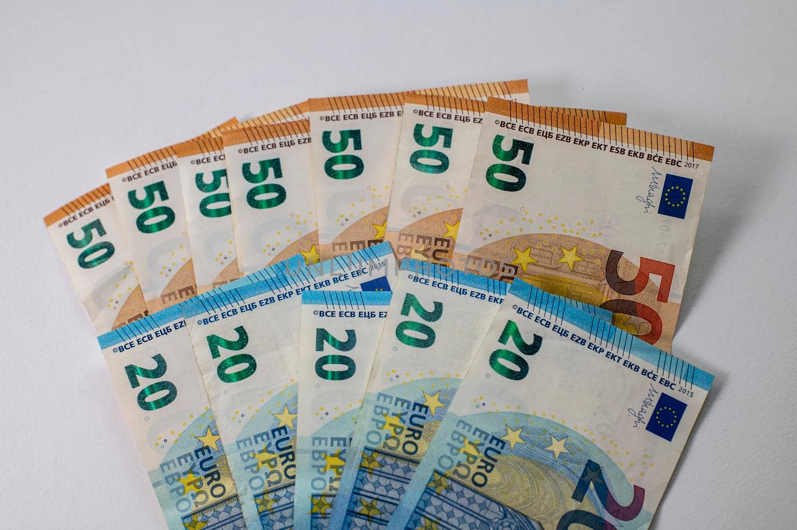 50 and 20 euro banknotes fanned out on a white background