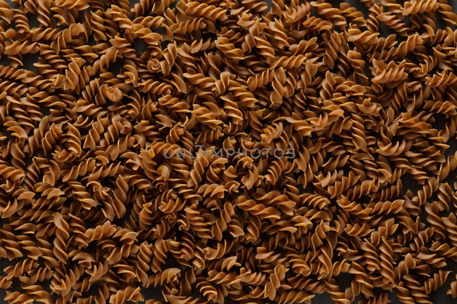 Top view of dark buckwheat pasta in dark key. High quality photo