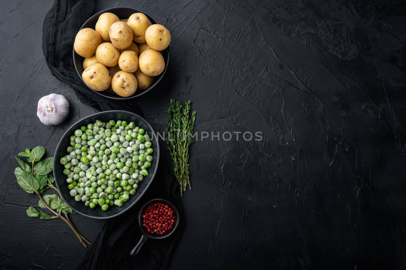 Mashed potatoes ingredient with green pea and mint, flat lay, on black textured background with space for text
