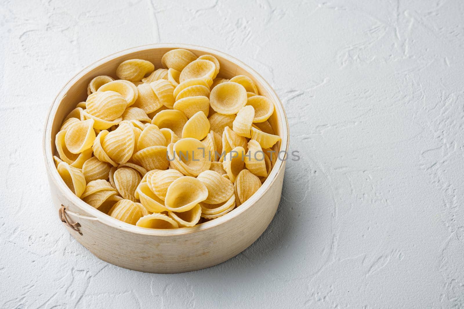 Semolina pasta dried, on white background with copy space for text
